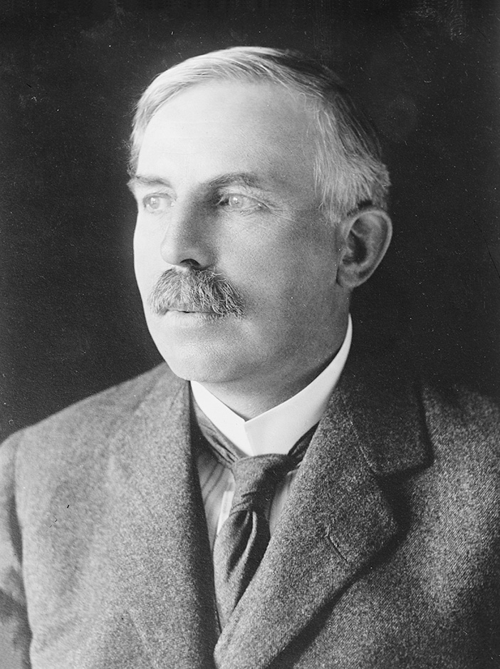 Ernest Rutherford in a suit, looking left off the camera